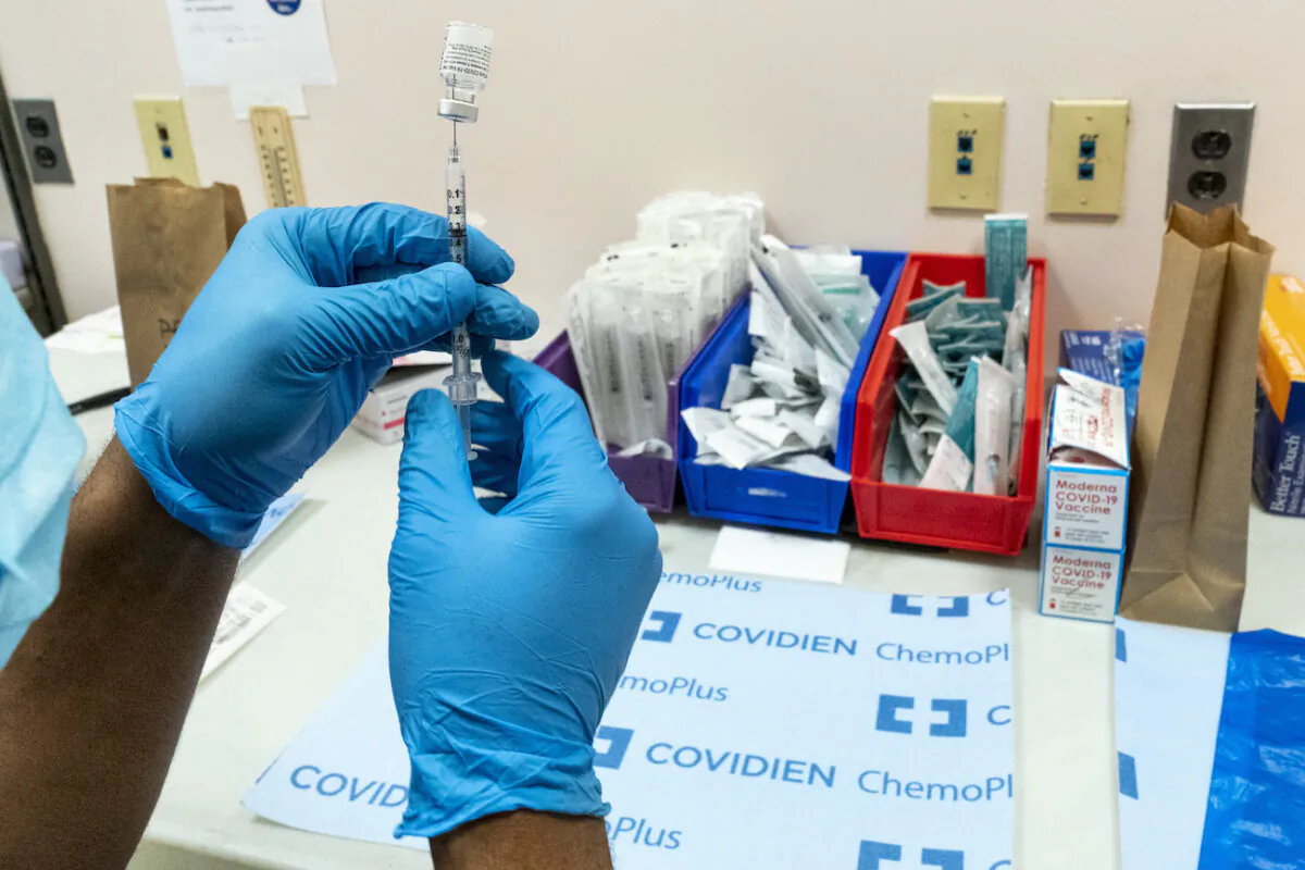 A pharmacist prepares a syringe with the Pfizer-BioNTech COVID-19 vaccine at a COVID-19 vaccination site at NYC Health + Hospitals Metropolitan, New York, on Feb. 18, 2021. (AP Photo/Mary Altaffer)