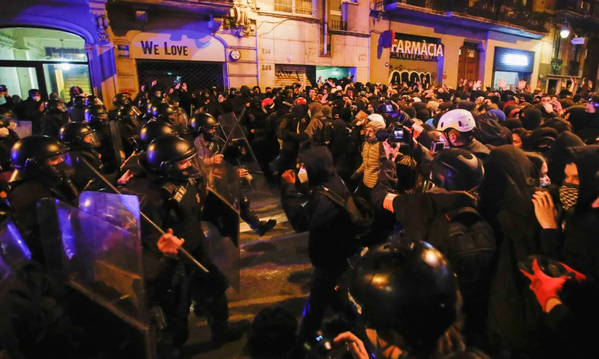Demonstrators clash with police as supporters of arrested Catalan rapper Pablo Hasel protest in Barcelona, Spain, on Feb. 20, 2021. (Albert Gea/Reuters)