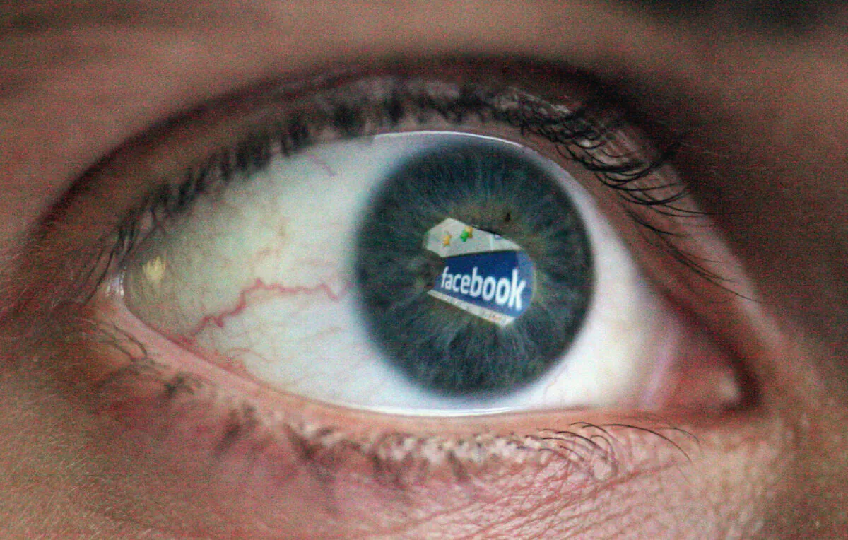 In this photo illustration the Social networking site Facebook is reflected in the eye of a man in London on March 25, 2009. (Dan Kitwood/Getty Images)