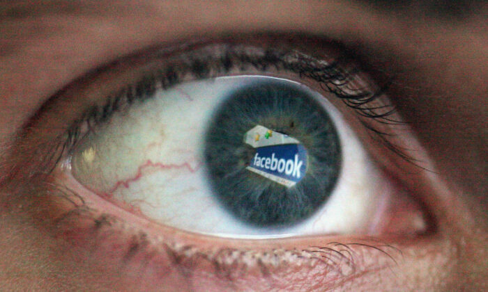 In this photo illustration the Social networking site Facebook is reflected in the eye of a man in London on March 25, 2009. (Dan Kitwood/Getty Images)