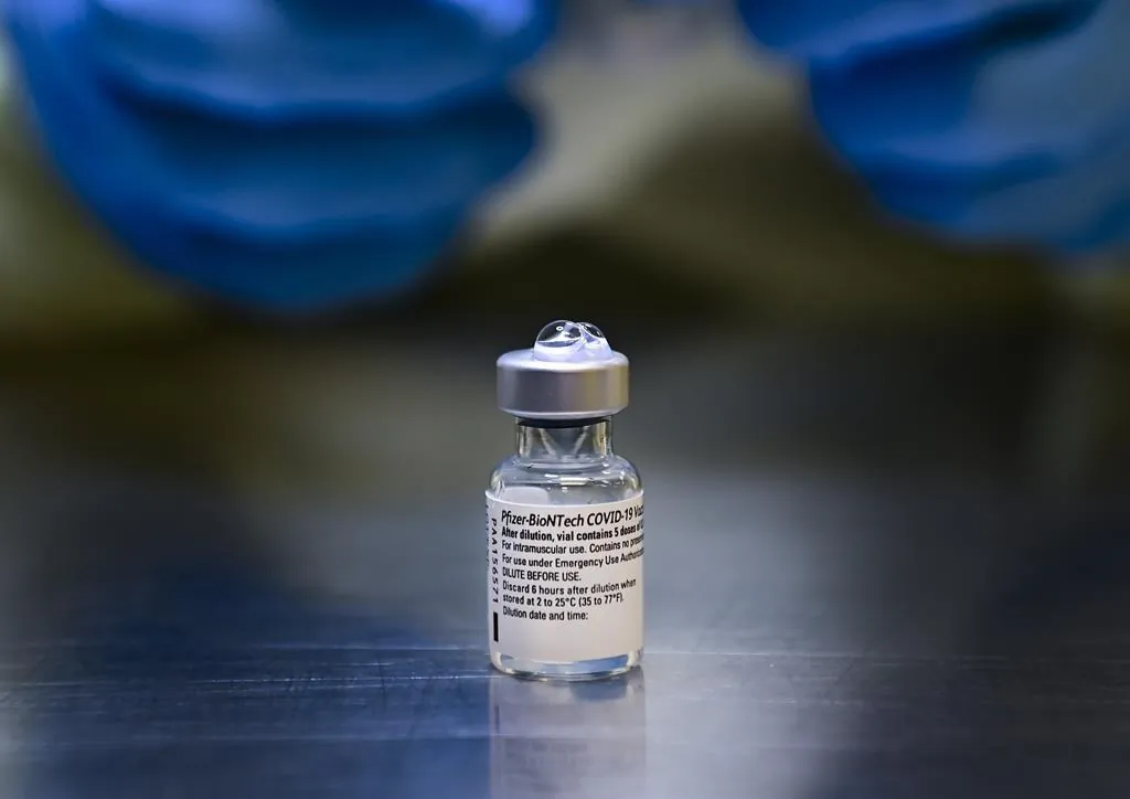 A health-care worker prepares a dose of the Pfizer-BioNTech COVID-19 vaccine at a UHN COVID-19 vaccine clinic in Toronto on January 7, 2021. (Nathan Denette/The Canadian Press)