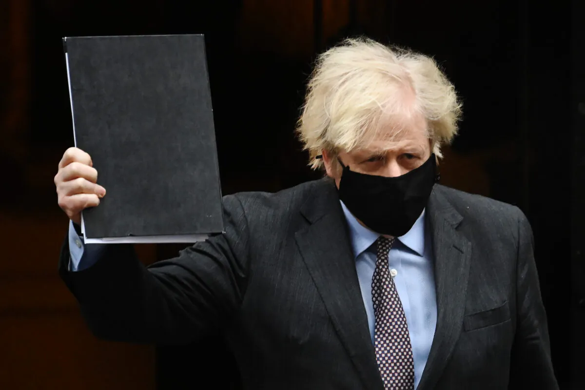 UK Prime Minister Boris Johnson leaves Downing Street on his way to the House of Commons to deliver a statement on the government’s four-step plans to release England from the current lockdown restrictions, on Feb. 22, 2021. (Leon Neal/Getty Images)