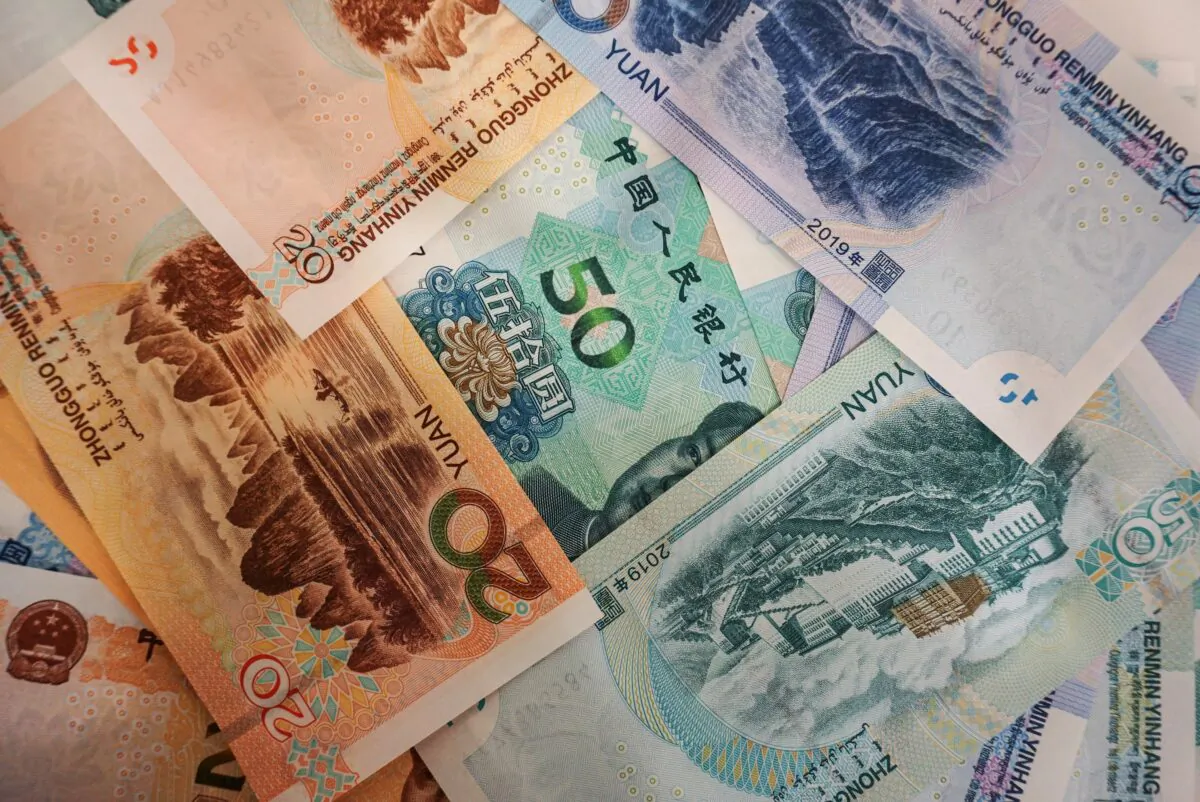 Chinese yuan banknotes are seen on a table at a bank counter in Hangzhou, China, on Aug. 30, 2019. (STR/AFP via Getty Images)