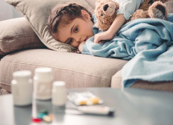 Sick,Little,Girl,Covered,In,Blanket,Is,Hugging,Teddy,Bear
