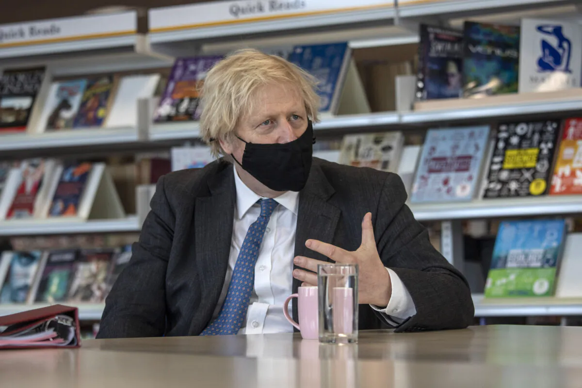 Prime Minister Boris Johnson meets teachers in the library as he visits Sedgehill School in southeast London, UK, on Feb. 23, 2021. (Jack Hill - WPA Pool/Getty Images)