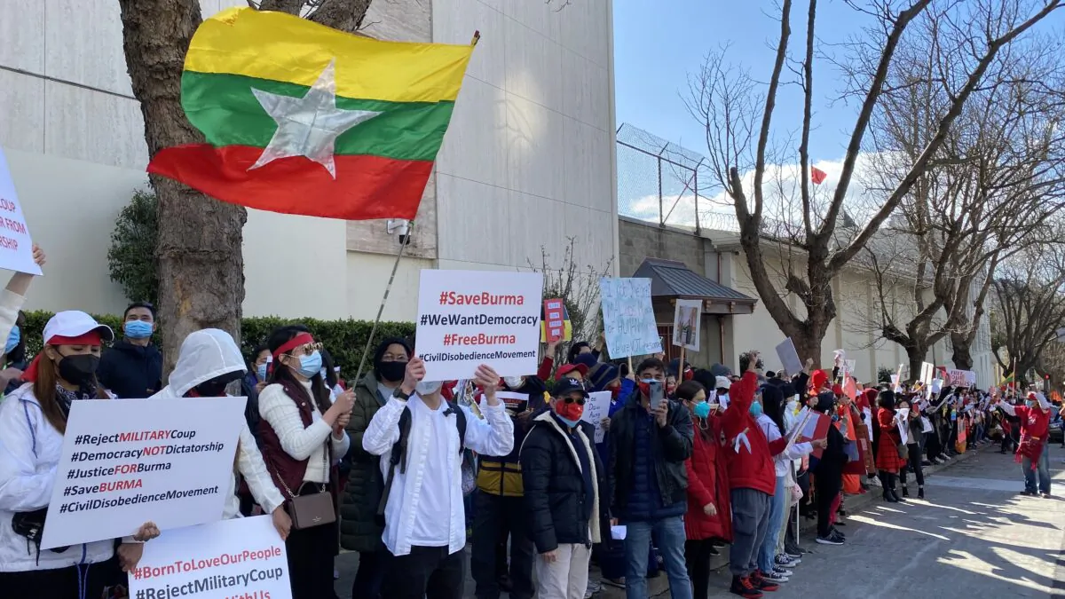 Protesters hold signs outside the Chinese Consulate in San Francisco on Feb. 20, 2021, to call for an end to the Chinese regime’s support for the Burmese military coup. (Nancy Han/The Epoch Times)