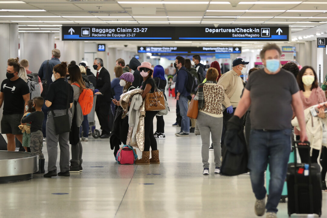People gather their luggage after arriving at Miami International Airport on a plane from New York in Miami, Fla., on Feb. 1, 2021. (Joe Raedle/Getty Images)