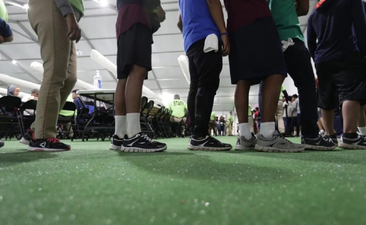 Immigrants line up in the dining hall at the U.S. government's newest holding center for migrant children in Carrizo Springs, Texas, on July 9, 2019. (Eric Gay/AP Photo)