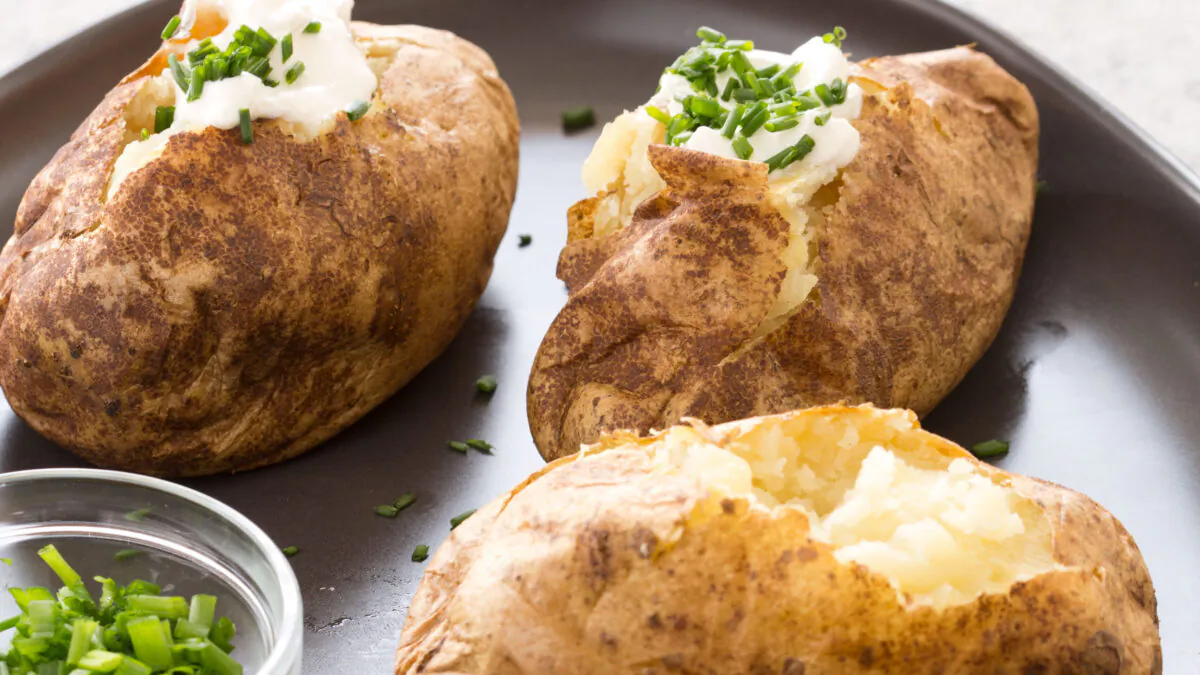 Painting the potatoes with vegetable oil once they’re cooked through results in a crispy skin. (Daniel J. van Ackere/TNS)