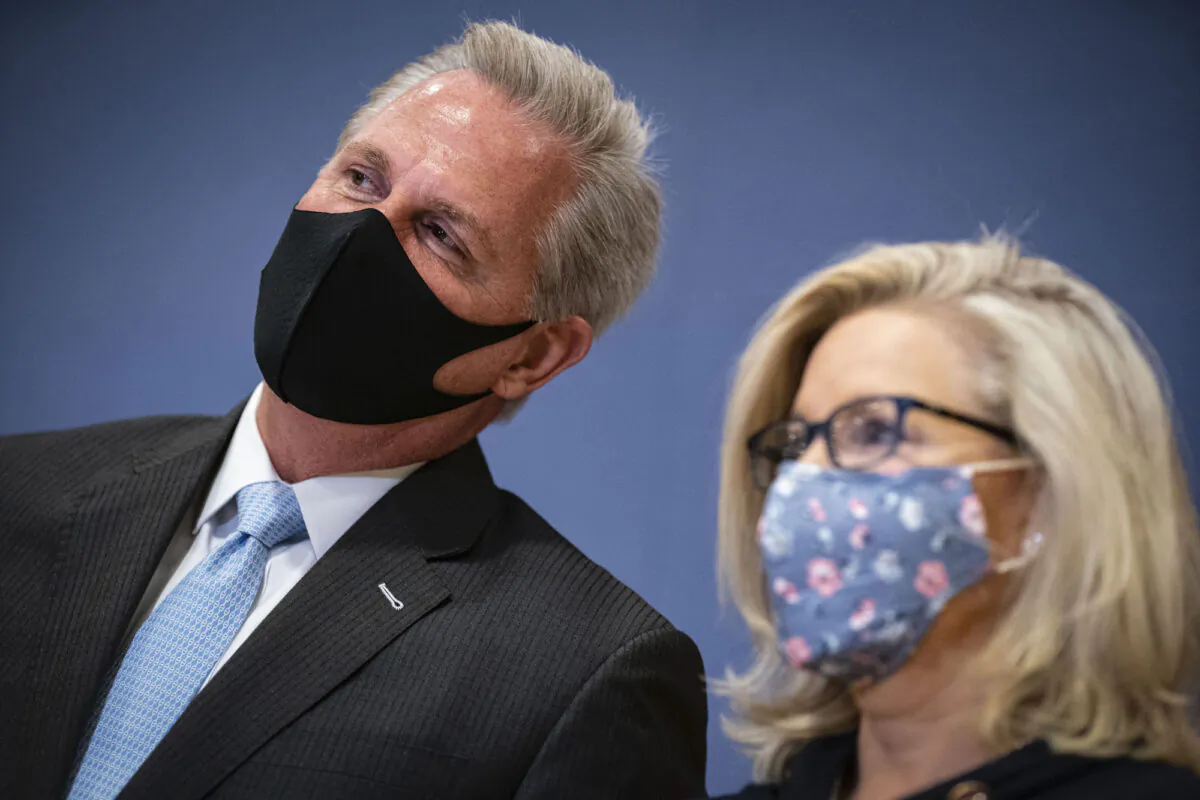 House Minority Leader Kevin McCarthy (R-Calif.) whispers to Rep. Liz Cheney (R-Wyo.) during a House Republican Leadership news conference in the U.S. Capitol in Washington on Feb. 24, 2021. (Al Drago/Getty Images)