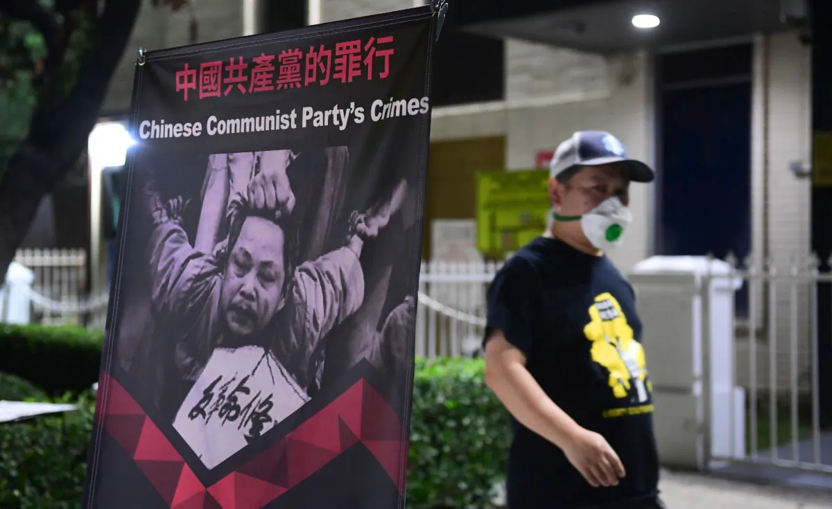 A poster is displayed in front of the Chinese Consulate in Los Angeles on Oct. 1, 2020, during a global day of action called by "Resist China" (#ResistChina), an international campaign to expose the crimes of the Chinese Communist Party. (Frederic J. Brown/AFP via Getty Images)