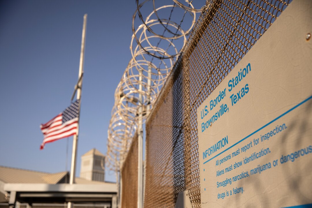The U.S. flag flies at half staff at a port of entry at the U.S.-Mexico border in Brownsville, Texas, on Feb. 24, 2021. (John Moore/Getty Images)