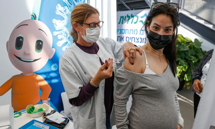 A health worker administers a dose of the Pfizer-BioNtech COVID-19 vaccine to a pregnant woman at Clalit Health Services, in Tel Aviv, Israel, on Jan. 23, 2021. (Jack Guez/AFP via Getty Images)