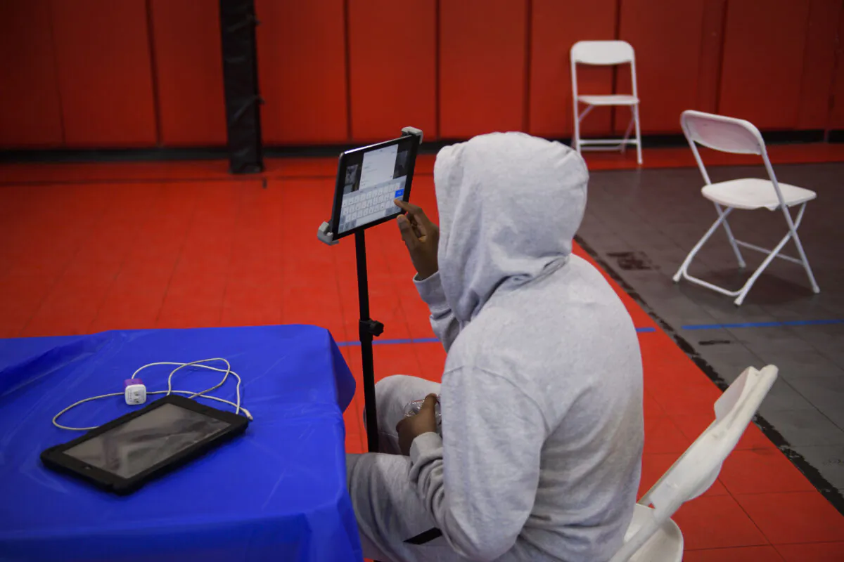 A youth attends an online class in a YMCA in Los Angeles, Calif., on Feb. 17, 2021. (Patrick T. Fallon/AFP via Getty Images)