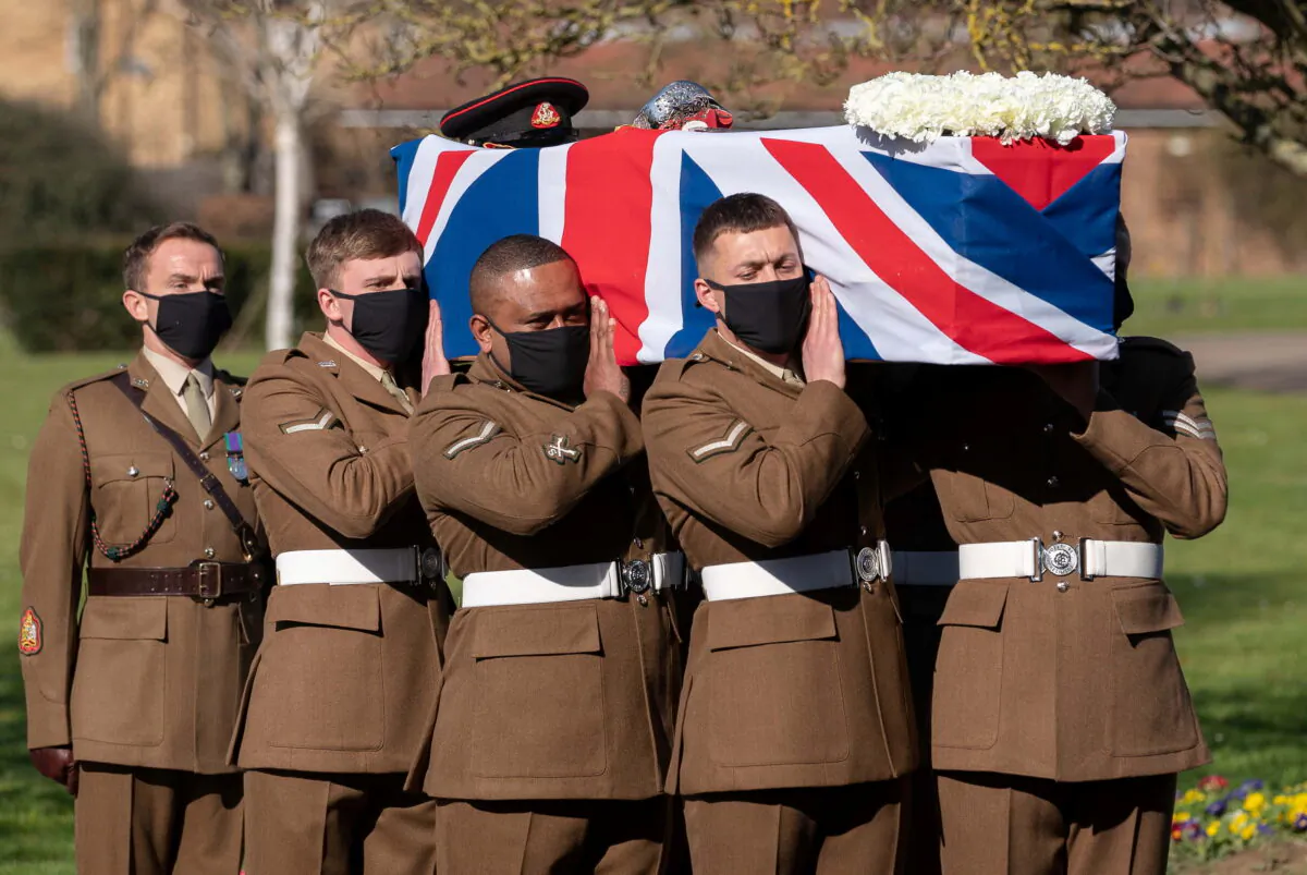 The coffin of Captain Sir Tom Moore is carried by members of the Armed Forces during his funeral at Bedford Crematorium, in Bedford, Britain, on Feb. 27, 2021. (Joe Giddens/Pool via Reuters)