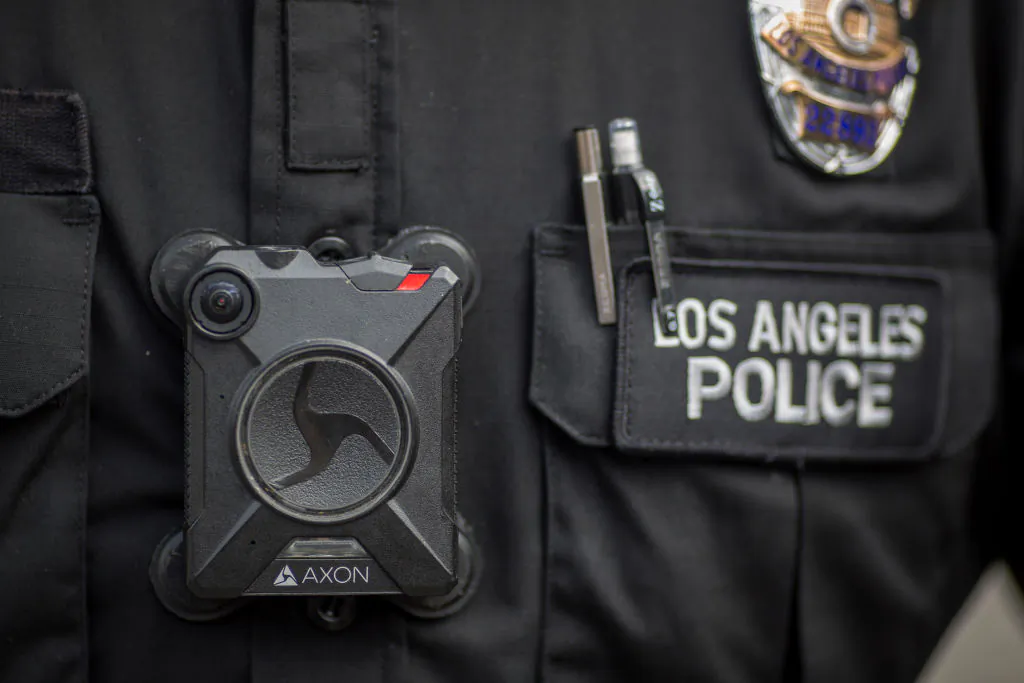 A Los Angeles police officer wears an Axon body camera during a Feb. 18, 2017, protest in Los Angeles, Calif. (Photo by David McNew/Getty Images)