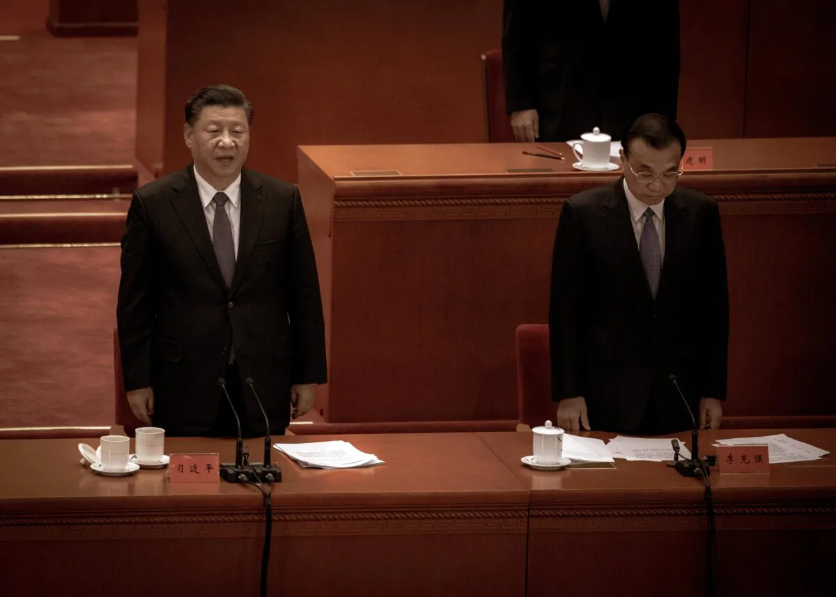 Chinese leader Xi Jinping (L) and Premier Li Keqiang sing the national anthem at a ceremony marking the 70th anniversary of China's entry into the Korean War, at the Great Hall of the People in Beijing, China on Oct. 23, 2020. (Kevin Frayer/Getty Images)