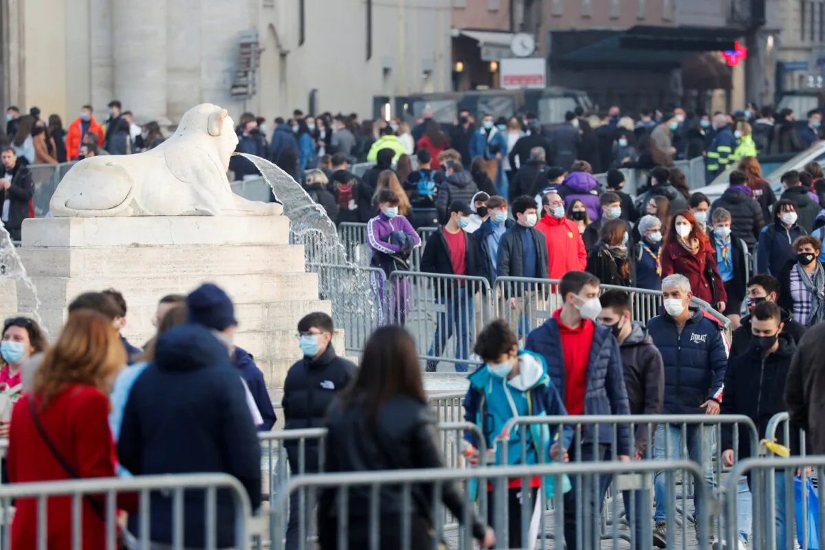 Barriers to control the pedestrian traffic are seen as people walk at Piazza del Popolo, in Rome, Italy, Feb. 27, 2021. (Remo Casilli/Reuters)
