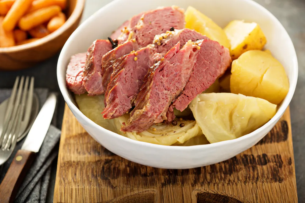 This now-iconic dish started with Irish immigrants in Jewish neighborhoods in Boston and New York, cooking corned brisket from the deli Irish-style: in a pot with cabbage and potatoes. (Elena Veselova/Shutterstock)