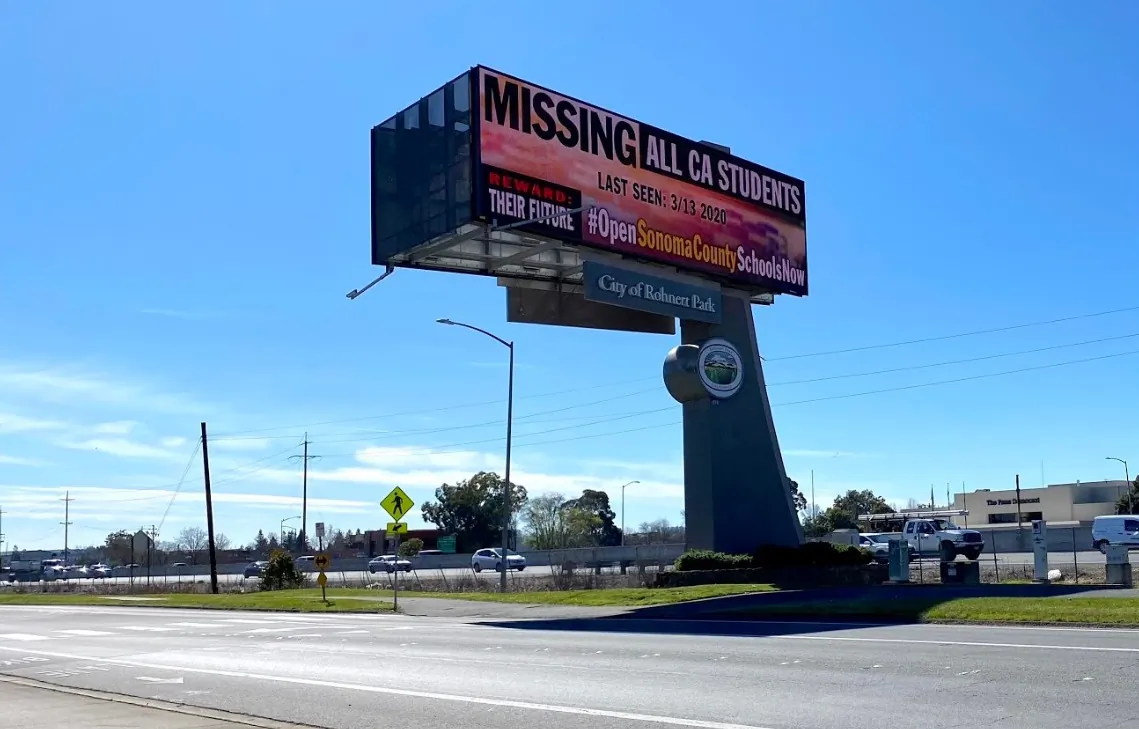 An electronic billboard calls for the reopening of schools, next to Highway 101 in Rohnert Park, Calif., on Feb. 25, 2021. (Ted Lin/The Epoch Times)
