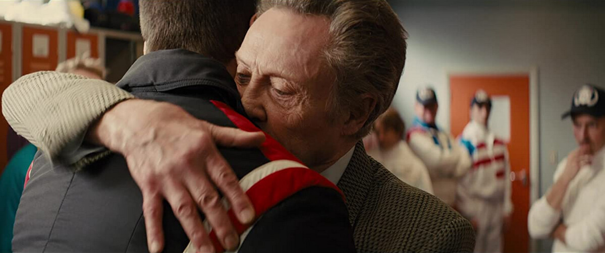 two men hug in "Eddie the Eagle"