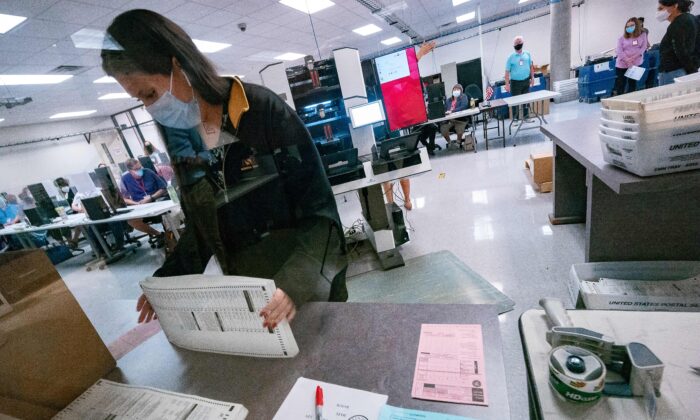 A poll worker sorts ballots inside the Maricopa County Election Department in Phoenix, Arizona on Nov. 5, 2020. (Olivier Touron/AFP via Getty Images)