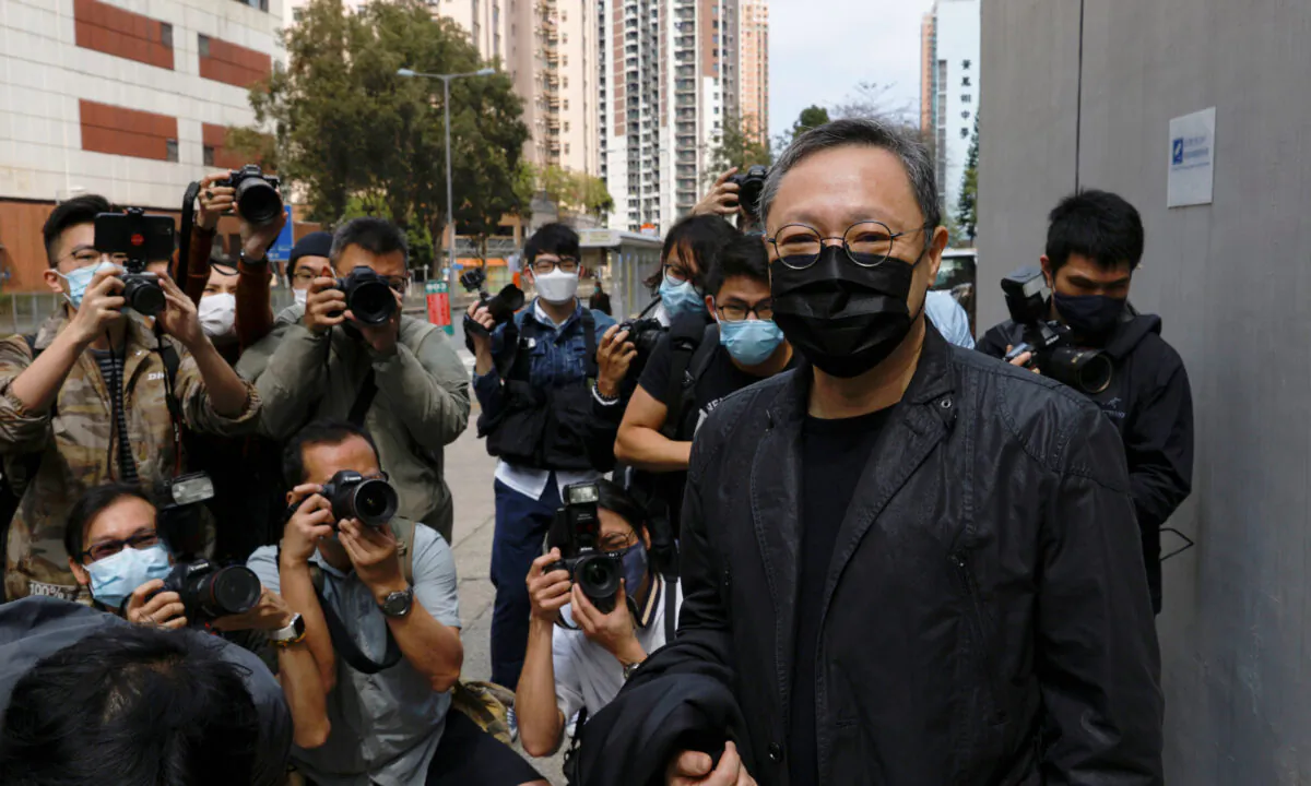 Pro-democracy activist Benny Tai is greeted by media members as he arrives to report to the police station over national security law charges in Hong Kong on Feb. 28, 2021. (Tyrone Siu/Reuters)