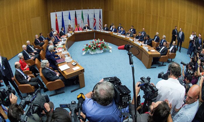 U.S. Secretary of Energy Ernest Moniz, U.S. Secretary of State John Kerry, British Foreign Secretary Philip Hammond, Russian Foreign Minister Sergey Lavrov, German Foreign Minister Frank Walter Steinmeier, French Foreign Minister Laurent Fabius, Chinese Foreign Minister Wang Yi, High Representative of the European Union for Foreign Affairs and Security Policy Federica Mogherini, Iranian Foreign Minister Mohammad Javad Zarif and the head of the Iranian Atomic Energy Organization Ali Akbar Salehi and the Iranian delegation (L-R) meet during a plenary session at the United Nations building in Vienna, Austria, on July 14, 2015. (Joe Klamar/Reuters)