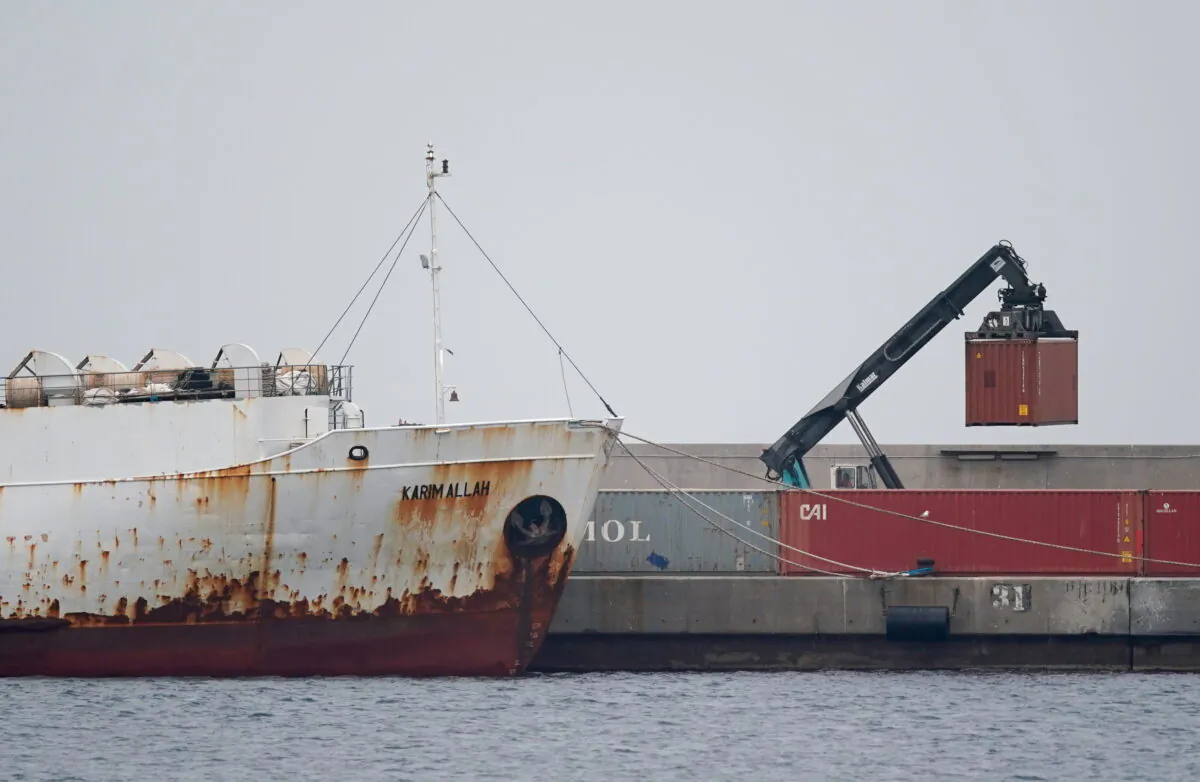 A crane moves a container next to livestock ship "Karim Allah," that carries nearly a thousand Spanish cattle stranded on ship with suspected bluetongue disease, at Escombreras port, in Cartagena, Spain, Feb. 27, 2021. (Juan Medina/Reuters)