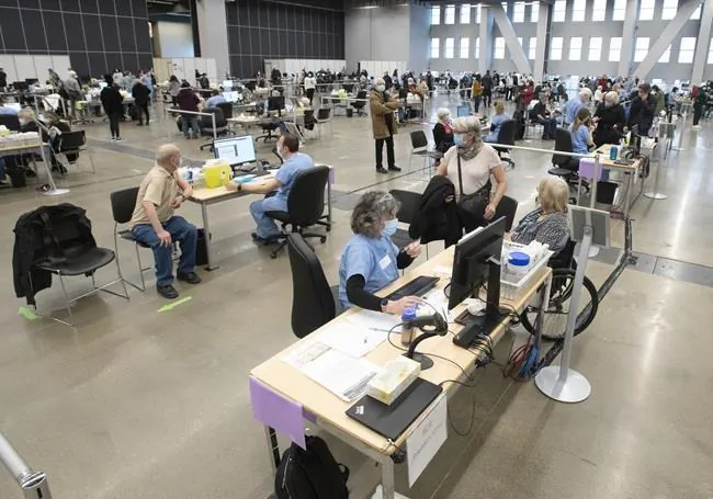 Seniors receive their COVID-19 vaccinations at the Palais de Congress site as Quebec begins mass vaccinations based on age across the province, on March 1, 2021 in Montreal. (Ryan Remiorz/The Canadian Press)