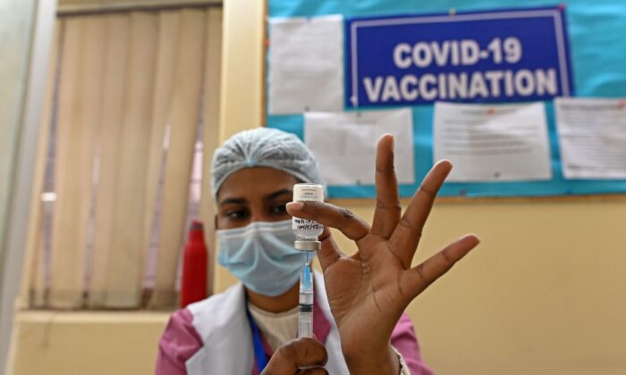 A medical worker prepares to administer a dose of the COVID-19 vaccine at a vaccination center in New Delhi, India, on Feb. 22, 2021. (Sajjad Hussain/AFP via Getty Images)