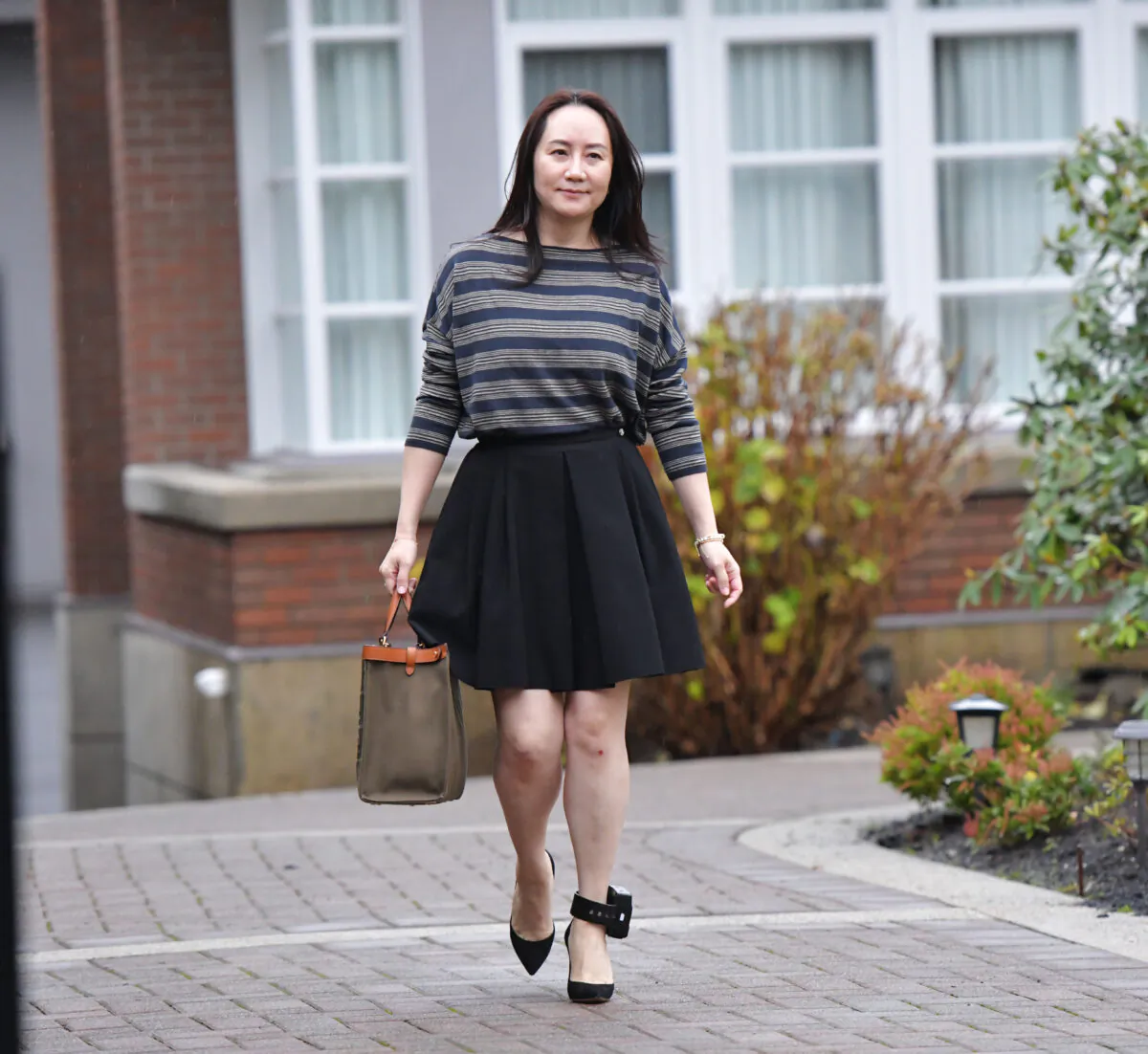 Huawei Chief Financial Officer, Meng Wanzhou, leaves her Vancouver home to attend British Columbia Supreme Court, in Vancouver, British Columbia on Dec. 8, 2020. (DON MACKINNON/AFP via Getty Images)