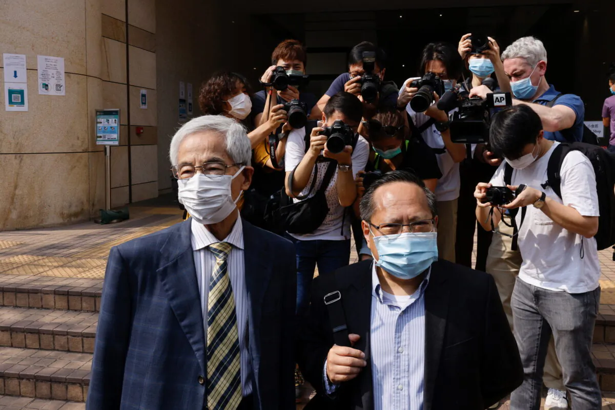 Democratic Party founder and barrister Martin Lee and Albert Ho arrive at the West Kowloon Courts for verdicts in the city's landmark unlawful assembly case, in Hong Kong on April 1, 2021. (Tyrone Siu/Reuters)