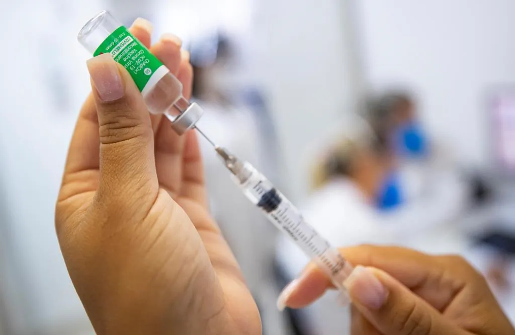 A nurse assistant prepares a dose of the Oxford-AstraZeneca vaccine for COVID-19 during a priority vaccination program for health workers at a community medical center in Sao Paulo, Brazil, Feb. 3, 2021. (AP Photo/Andre Penner)