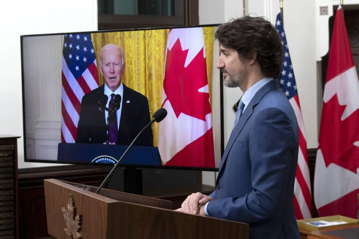 Prime Minister Justin Trudeau listens as U.S. President Joe Biden delivers a statement following a virtual meeting between the two leaders, in Ottawa on Feb. 23, 2021. (The Canadian Press/Adrian Wyld)
