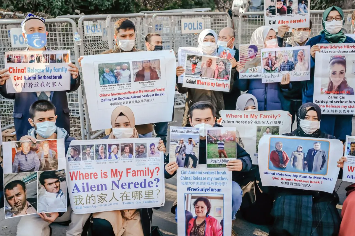 Members of the Uyghur community in Istanbul, Turkey, hold placards to ask for news of their relatives in China on Dec. 30, 2020. (Bulent Kilic/AFP via Getty Images)