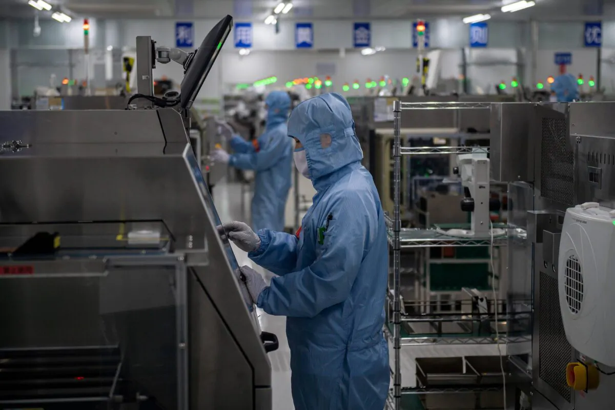 Workers are seen inside the production chain at a semiconductor manufacturing factory in Beijing, China, on May 14, 2020. (Nicolas Asfouri/AFP via Getty Images)