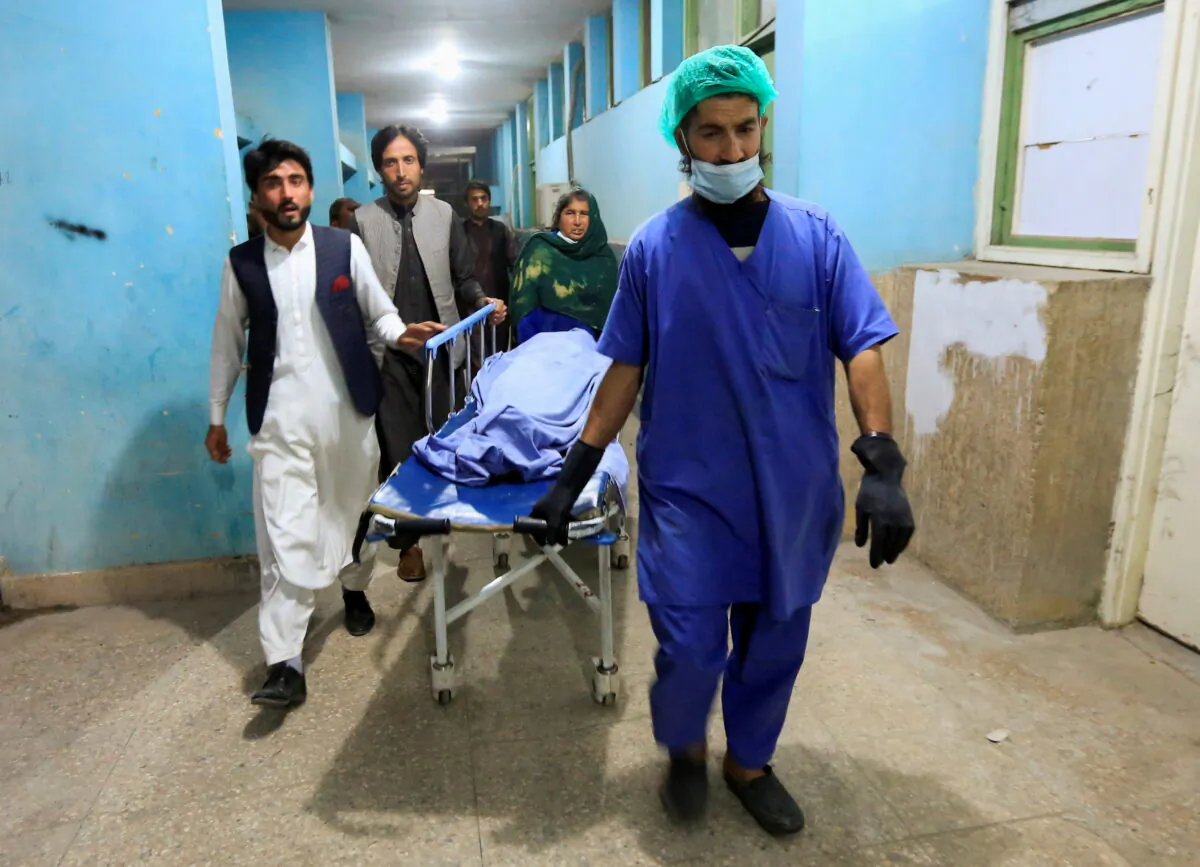 Afghan men transport the body of one of three media workers who were killed by an unknown gunmen, at a hospital in Jalalabad, Afghanistan, on March 2, 2021.
(Parwiz/Reuters)