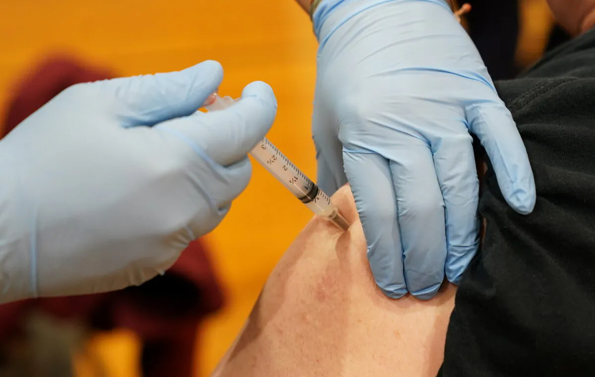 A man receives the boost dose at a COVID-19 community vaccination event, as West Virginia's vaccination rate ranks among highest in world, in Martinsburg, W.Va., on 25, 2021. (Kevin Lamarque/Reuters)
