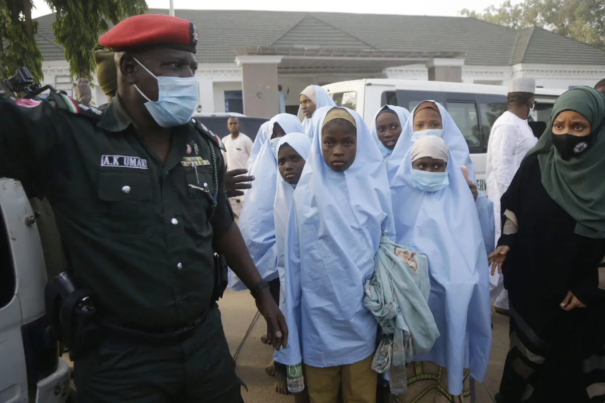 Some of the students who were abducted by gunmen from the Government Girls Secondary School in Jangebe last week, wait for a medical checkup after their release in Gusau, northern Nigeria, on March 2, 2021. (Sunday Alamba/AP Photo)