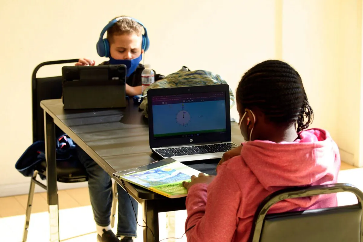 Children attend online classes at a learning hub inside the Crenshaw Family YMCA during the Covid-19 pandemic in Los Angeles on Feb. 17, 2021. (Patrick T. Fallon/AFP via Getty Images)