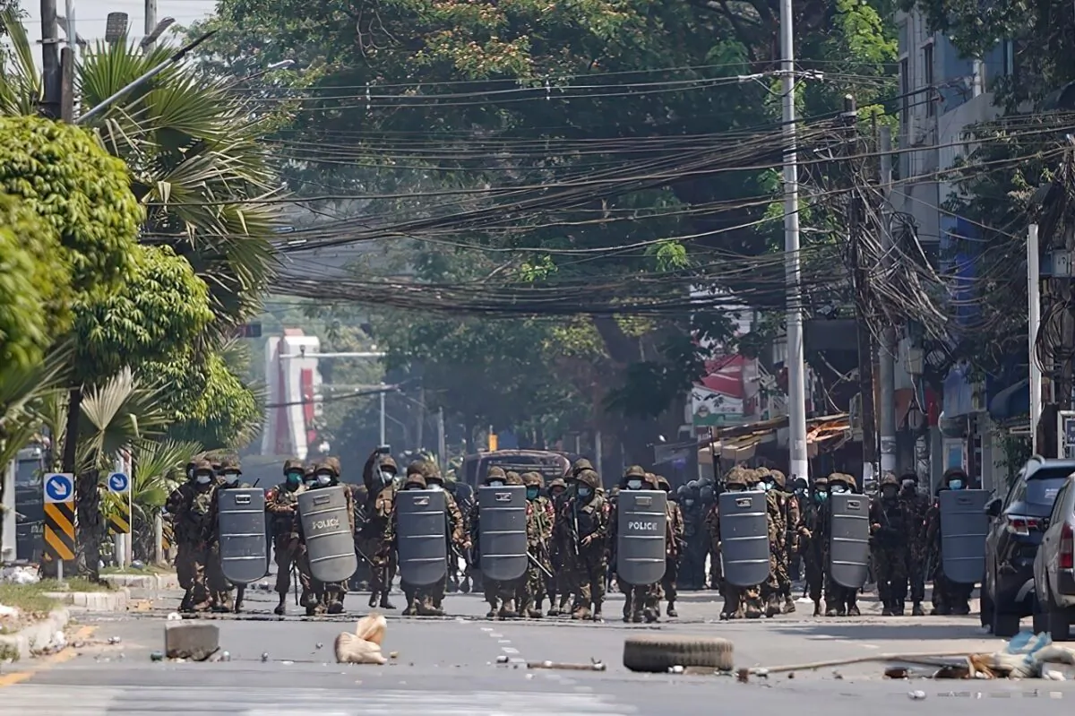 The Burmese military with shields moves forward during a protest against the military coup in Yangon, Burma, on March 2, 2021. (AP Photo)