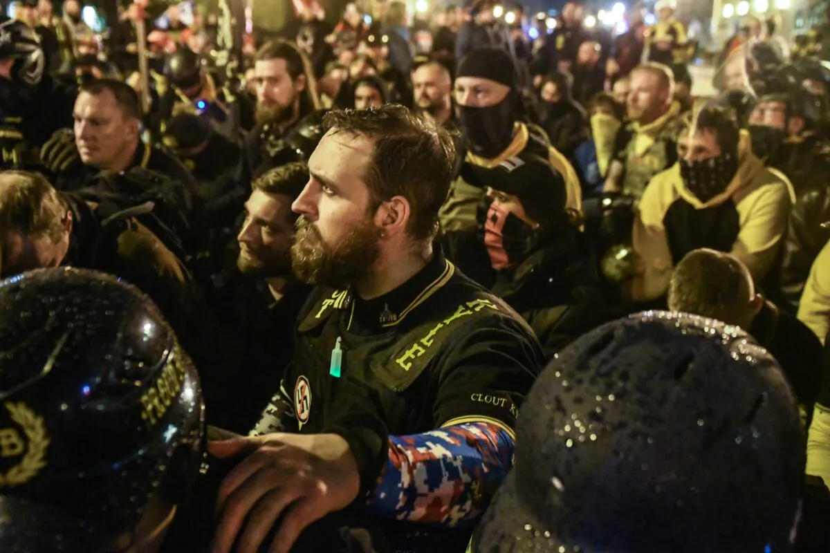 Members of the Proud Boys pray for a member who was stabbed during a protest in Washington on Dec. 12, 2020. (Stephanie Keth/Getty Images)