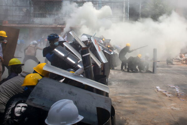 Protesters cover with makeshift shields