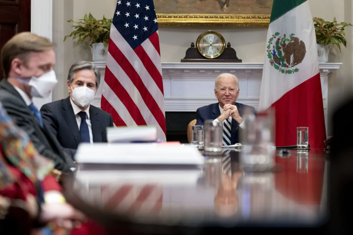 President Joe Biden, accompanied by White House national security adviser Jake Sullivan, left, and Secretary of State Antony Blinken, second from left, attends a virtual meeting with Mexican President Andres Manuel Lopez Obrador, in the Roosevelt Room of the White House on March 1, 2021. (Andrew Harnik/AP Photo)