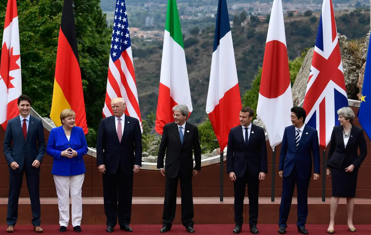 From left: Canadian PM Justin Trudeau, German Chancellor Angela Merkel, U.S. President Donald Trump, Italian PM Paolo Gentiloni, French President Emmanuel Macron, Japanese PM Shinzo Abe, and Britain's PM Theresa May, pose for a family photo at the ancient Greek Theatre of Taormina during the Heads of State and of Government G7 summit in Sicily on May 26, 2017. (Miguel Medina/AFP via Getty Images)
