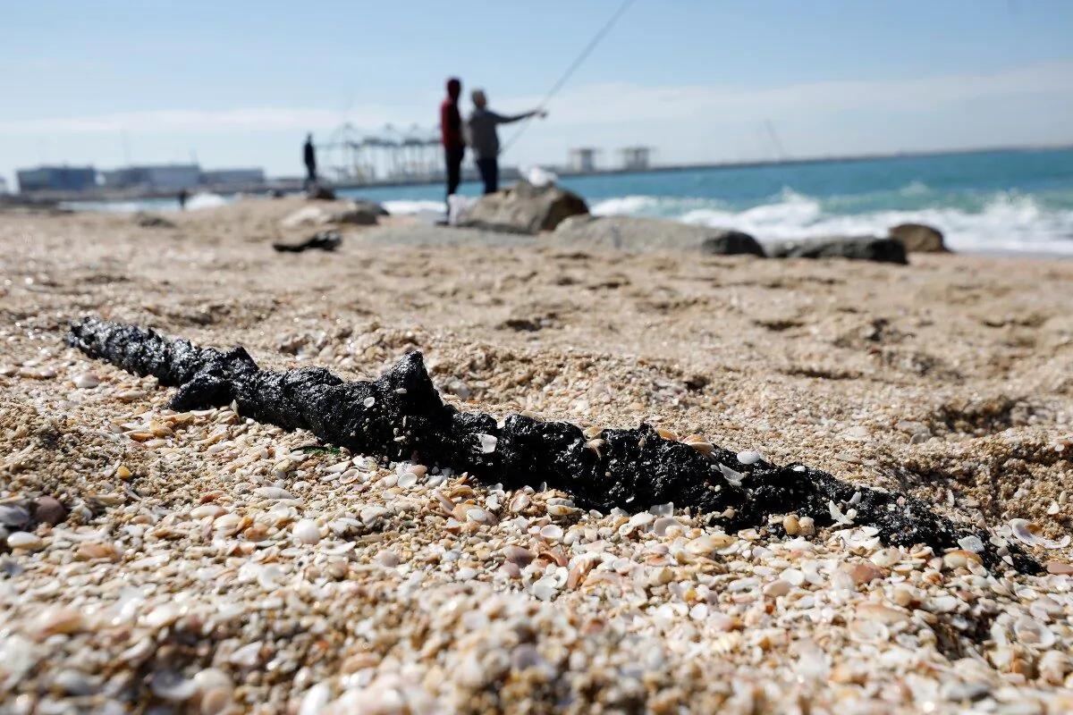 A clump of tar is seen on the sand after an offshore oil spill drenched much of Israel's Mediterranean shoreline with tar, at a beach in Ashdod, southern Israel, on Feb. 21, 2021. (Amir Cohen/File/Reuters)