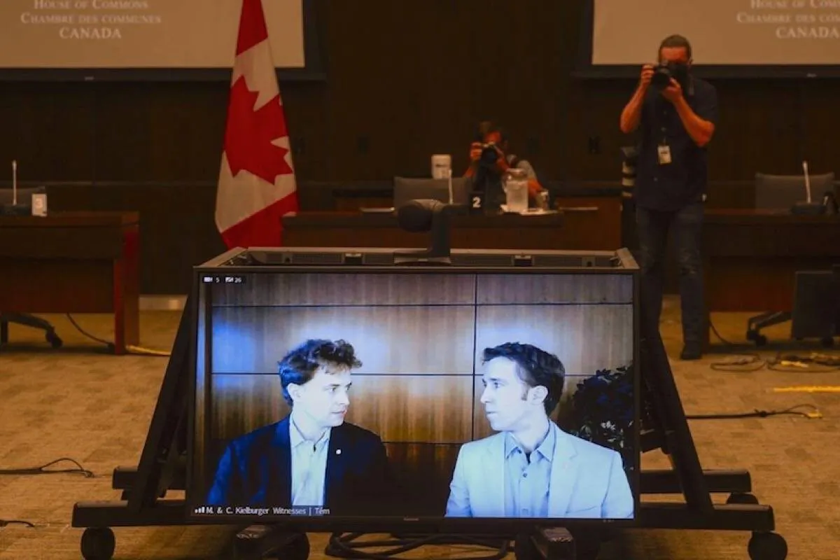 Marc Kielburger (L) and Craig Kielburger appear as witnesses via videoconference during a House of Commons finance committee in the Wellington Building in Ottawa on July 28, 2020. (Sean Kilpatrick/The Canadian Press)