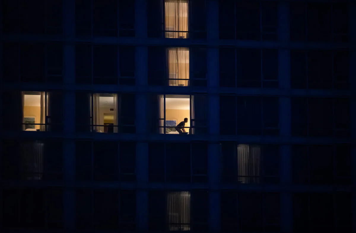 A person is seen in a room at a government-authorized COVID-19 quarantine hotel in Richmond, B.C., Canada, on Feb. 28, 2021. (Darryl Dyck/The Canadian Press)