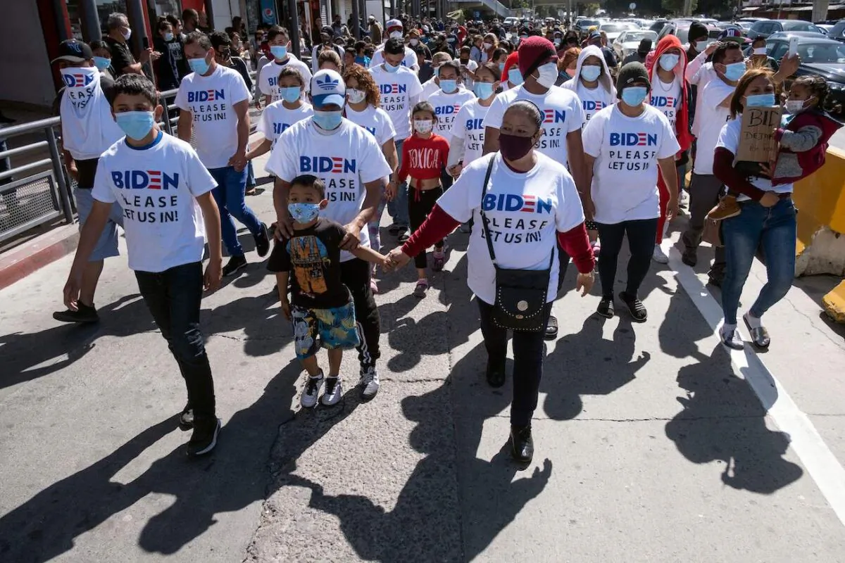 Migrants hold a demonstration demanding clearer United States migration policies, at San Ysidro crossing port in Tijuana, Baja California state, Mexico, on March 2, 2021. (Guillermo Arias/AFP via Getty Images)